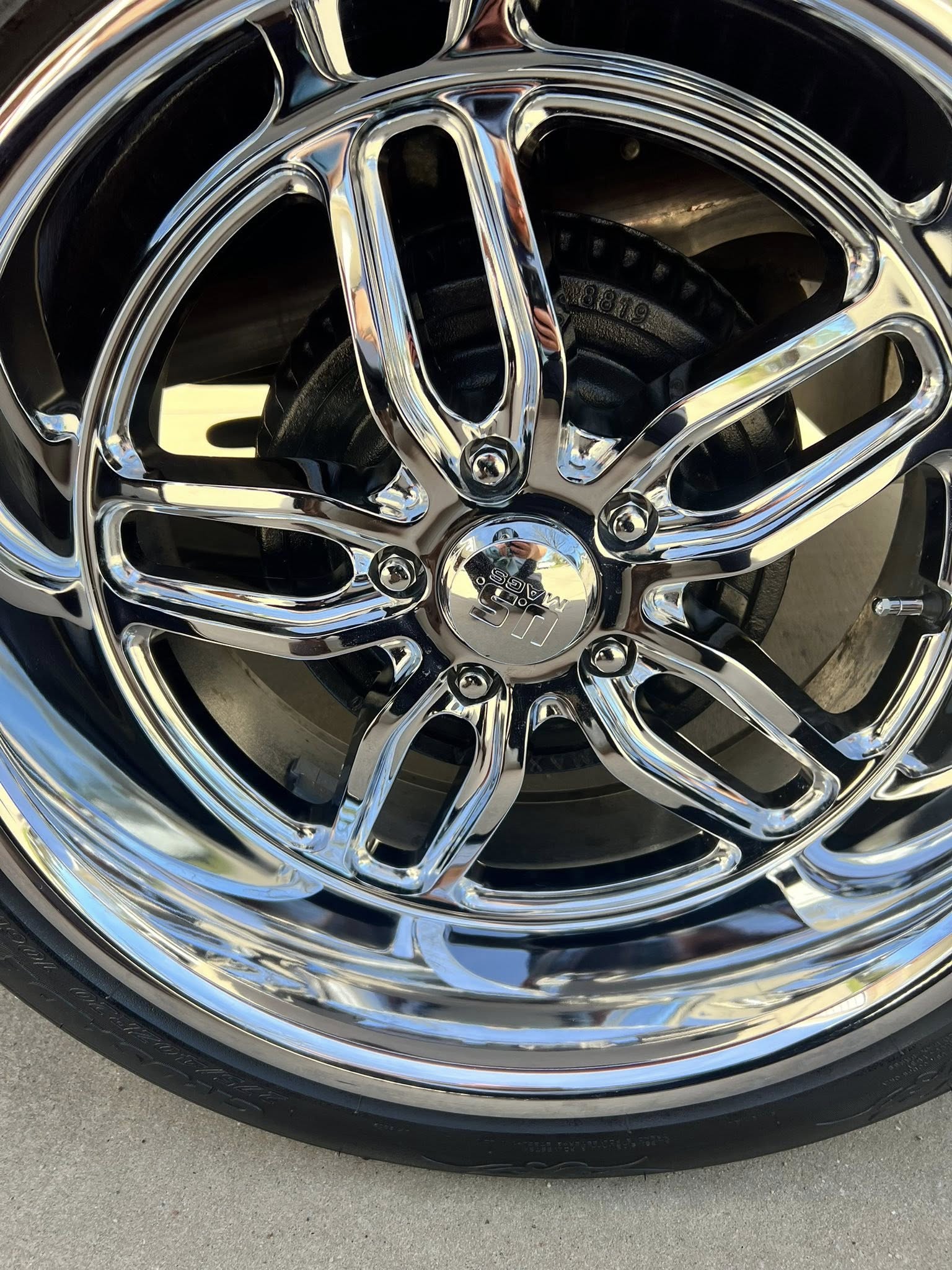 Polished chrome wheel after paint correction and buffing