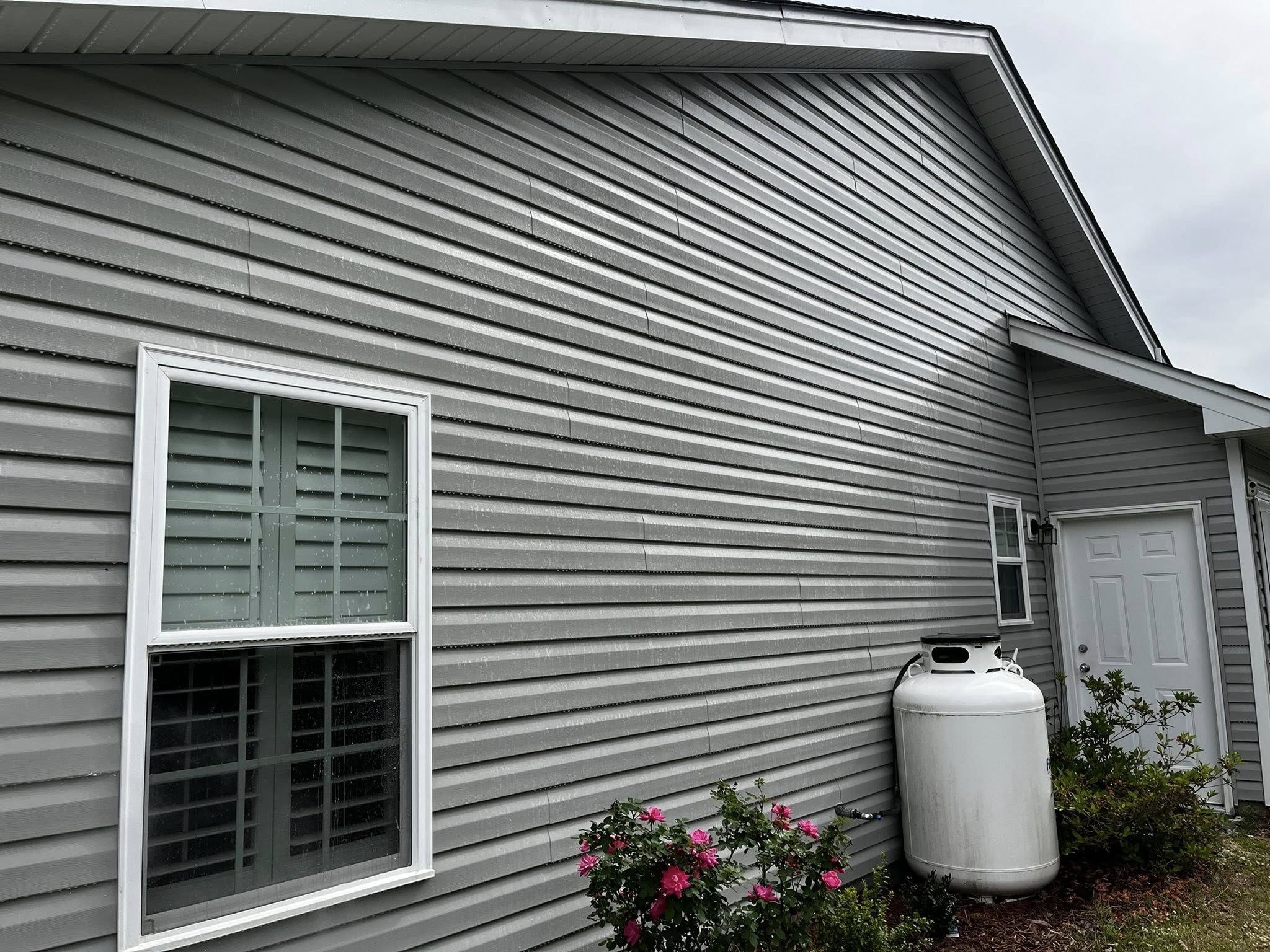 House with clean vinyl siding after pressure washing
