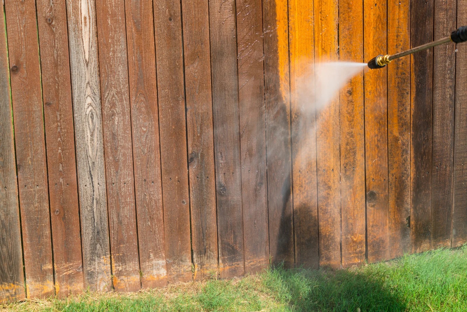 Pressure washing a wood fence